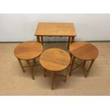 A mid century Danish nest of tables, the teak rectangular table incorporating three smaller circular