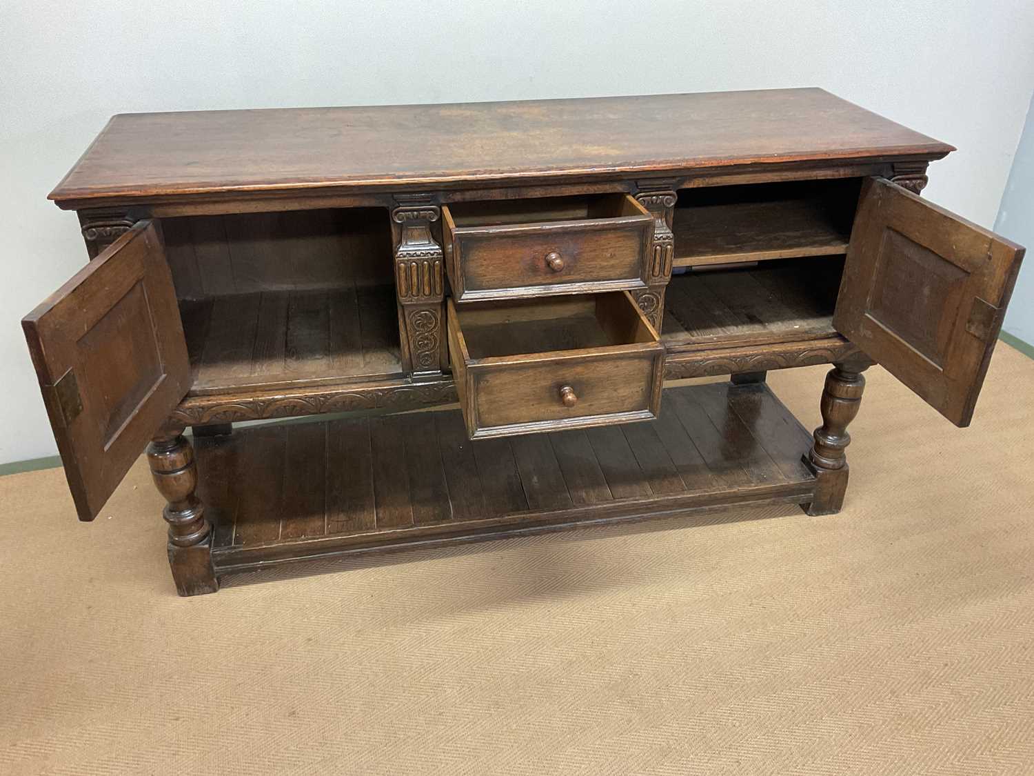 A carved oak sideboard, with two central drawers and two cupboards with lower undertier, height - Image 2 of 3