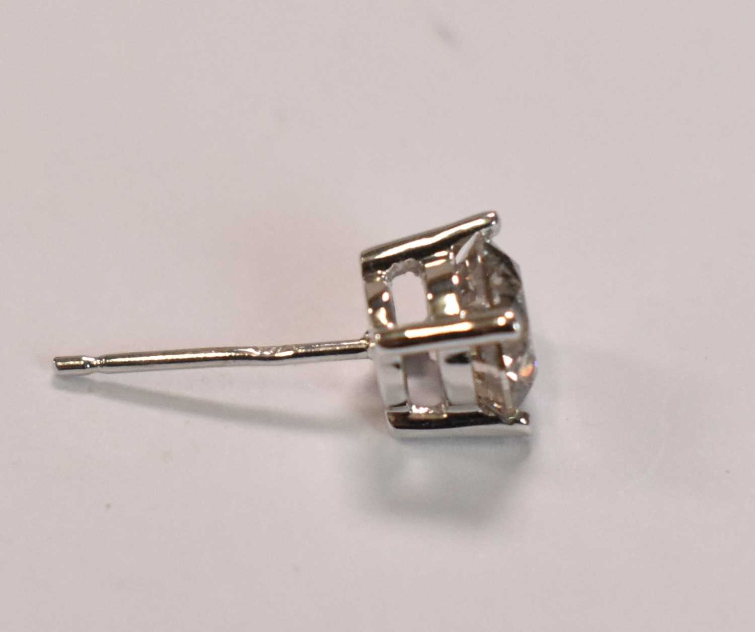 An 18ct yellow gold and single diamond ear stud, the round brilliant cut stone weighing approx - Image 2 of 2