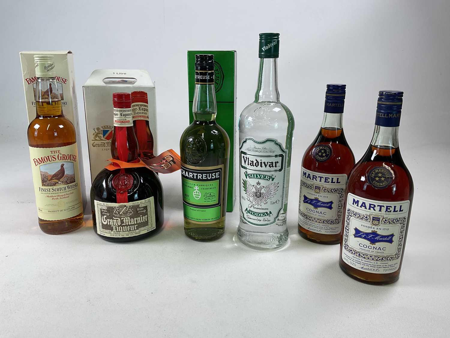 MIXED SPIRITS; six bottles comprising two bottles of Martell cognac, a 1 litre bottle Grand Marnier,