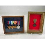 A set of four re-issued WWII medals, framed and glazed, and a single restruck medal in a separate