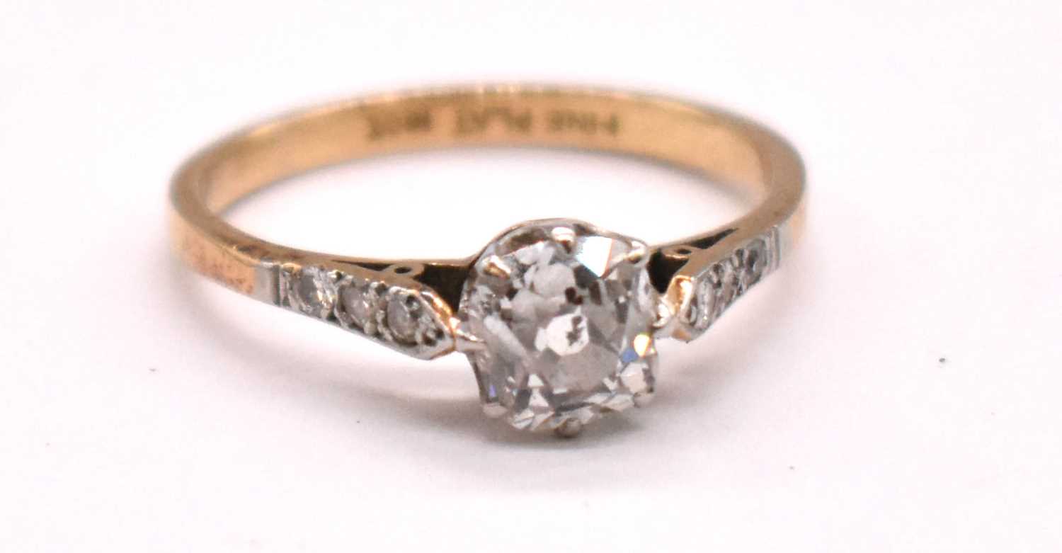 An early 20th century 18ct gold and platinum mounted diamond solitaire ring, the principal cushion