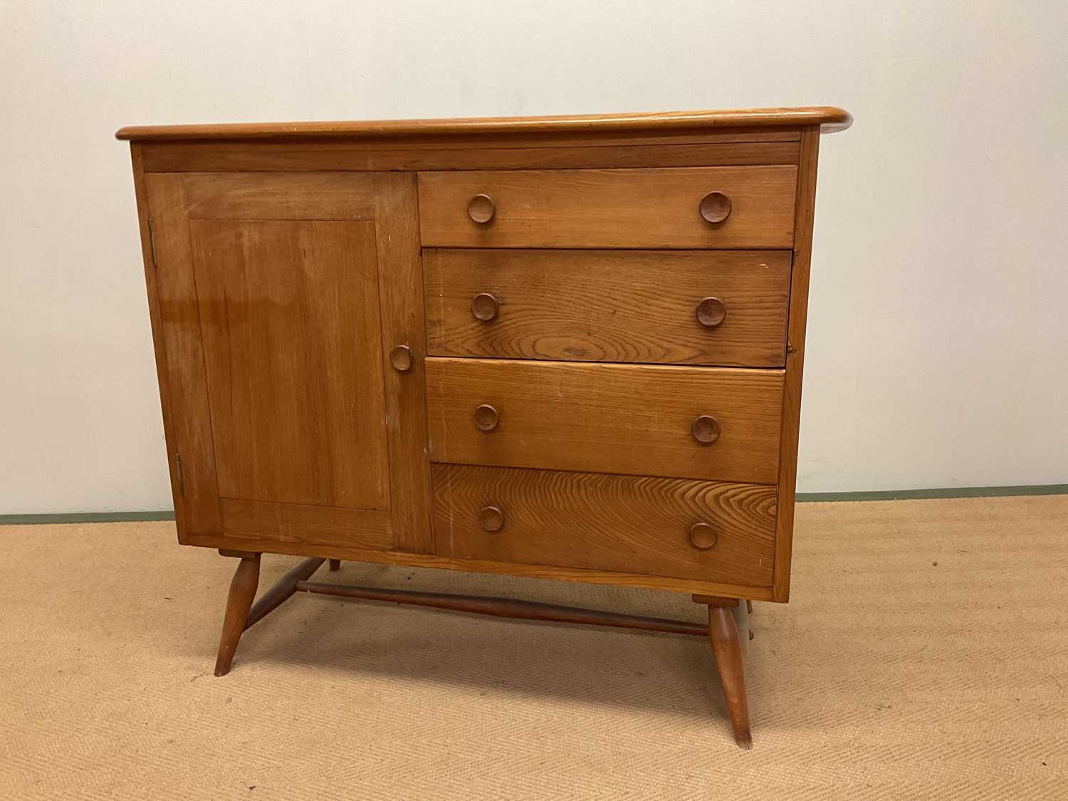 ERCOL; a mid century sideboard with four drawers including a cutlery drawer and a cupboard with