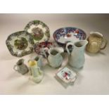 A collection of ceramics including a Beleek jug, graduated set of Portmeirion jugs and other items