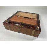 A burr walnut writing slope with brass strapping and corners, brass topped inkwells, escutcheons and