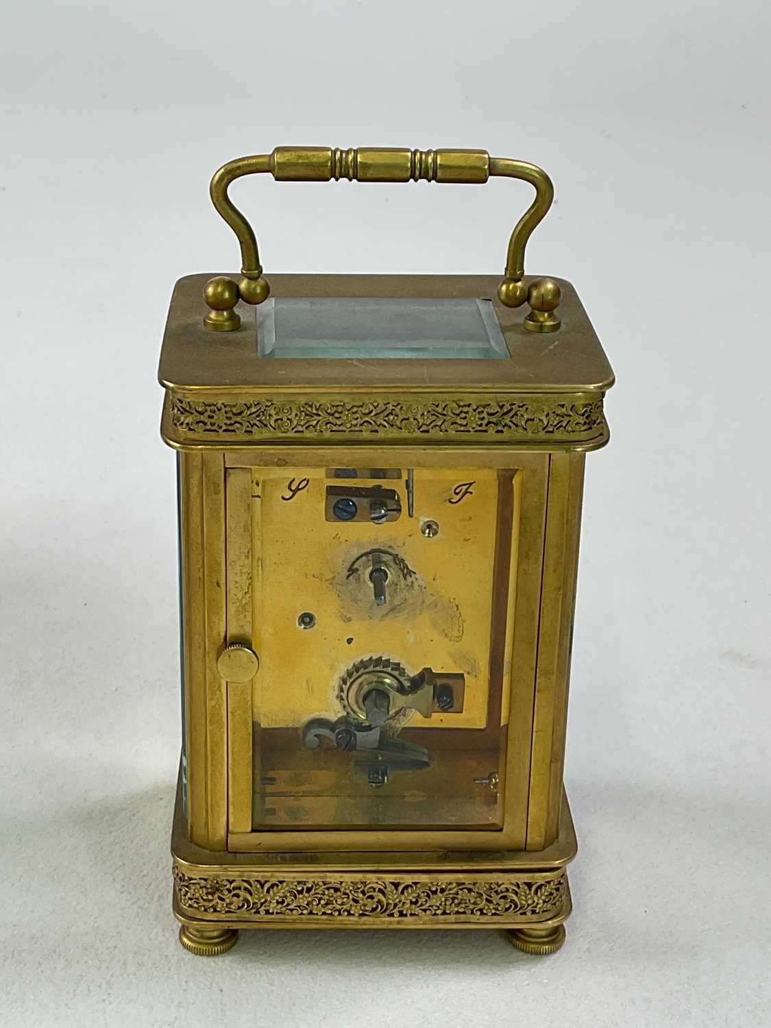 A brass carriage clock with pierced decoration to the case, the enamelled dial set with Arabic - Image 3 of 6
