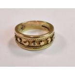 A 9ct yellow gold ring with sunken band decorated with stars and moons and set with three tiny