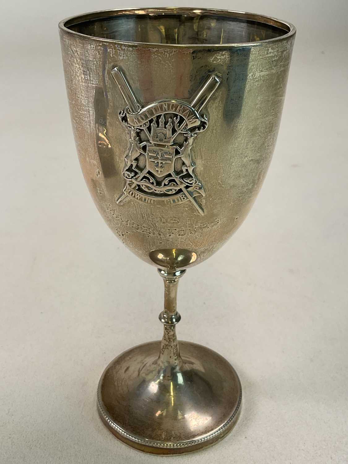 An Edwardian hallmarked silver goblet with applied crossed rowing oars and with armorial