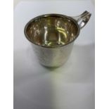 A George V hallmarked silver christening cup with exaggerated handle and plain bowl, inscribed 'Jane
