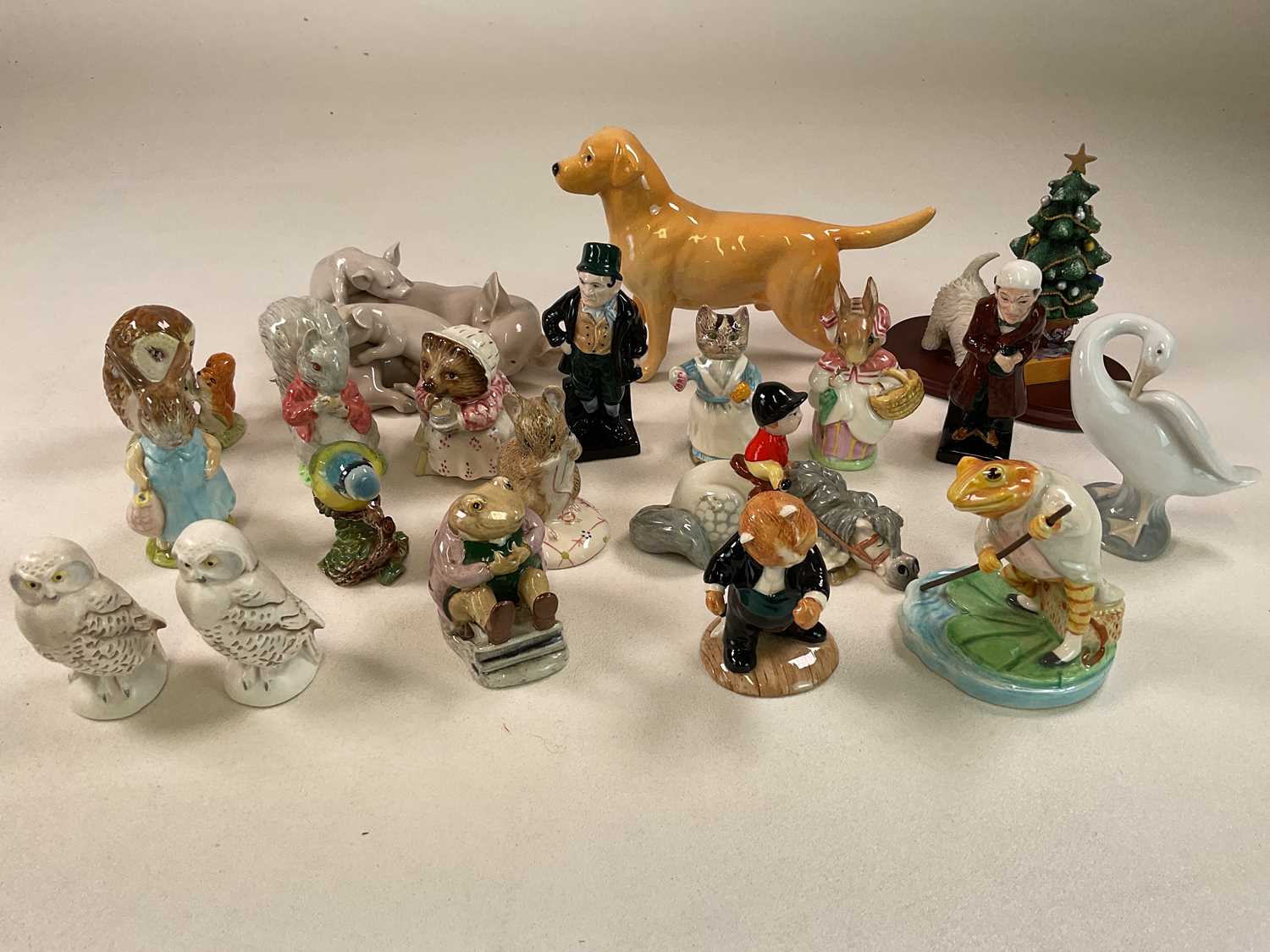 A large group of figures including a Lladrό pig group, a Beswick Norman Thelwell 'Kick-Start'