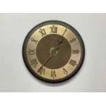 A 20th century large wall clock constructed of steel and brass with raised Roman numerals to the