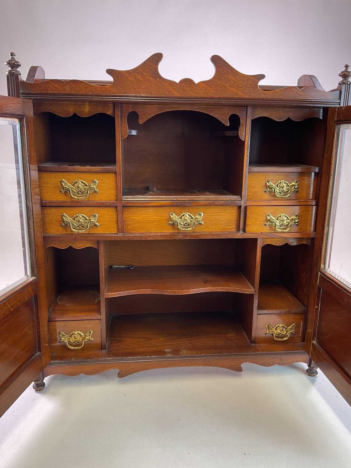 A Victorian oak smoker's cabinet with double glass doors and seven drawers and shelves to - Bild 2 aus 3