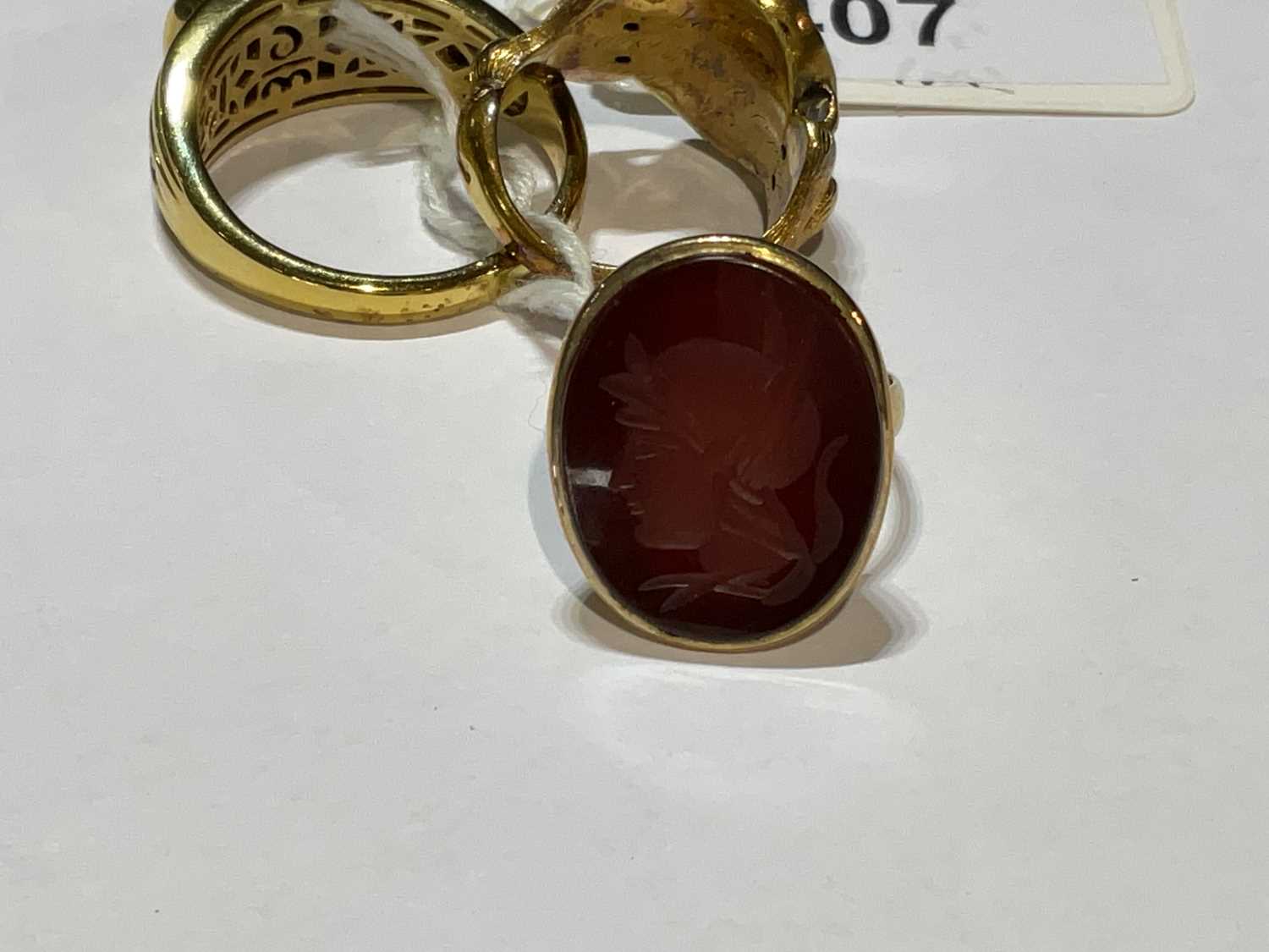 Three yellow metal rings, one set with a carved carnelian, size O, 4.9g approx one with central - Image 5 of 6