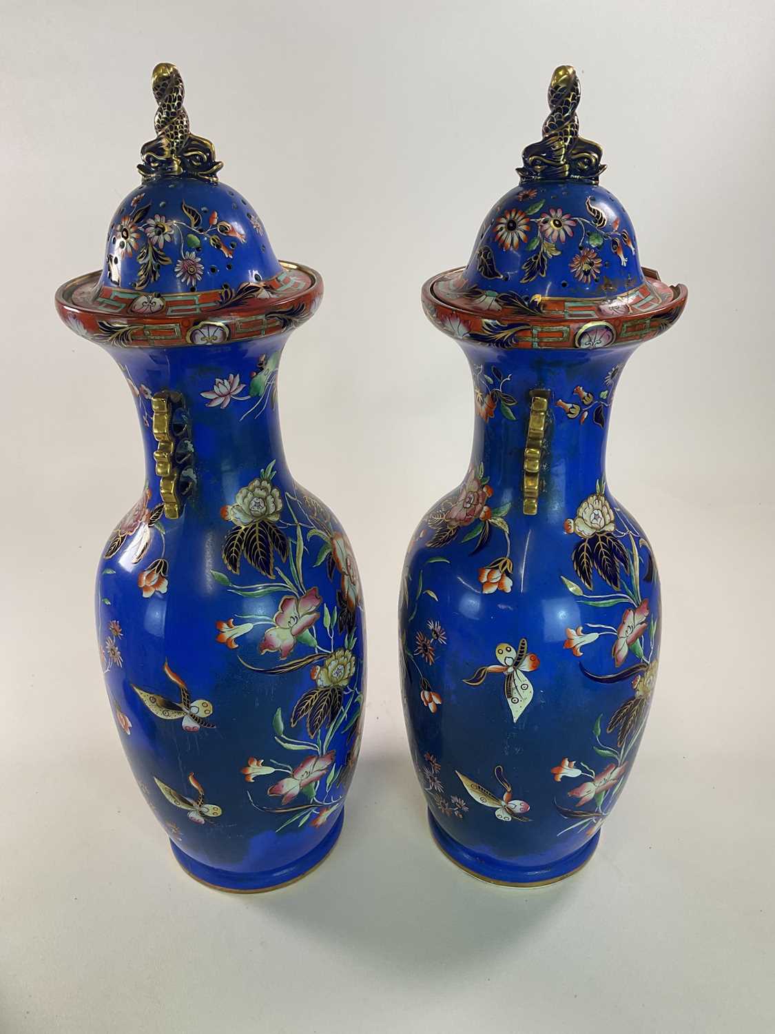 A very large pair of mid 19th century blue ground vases in the Chinoiserie style with stylised