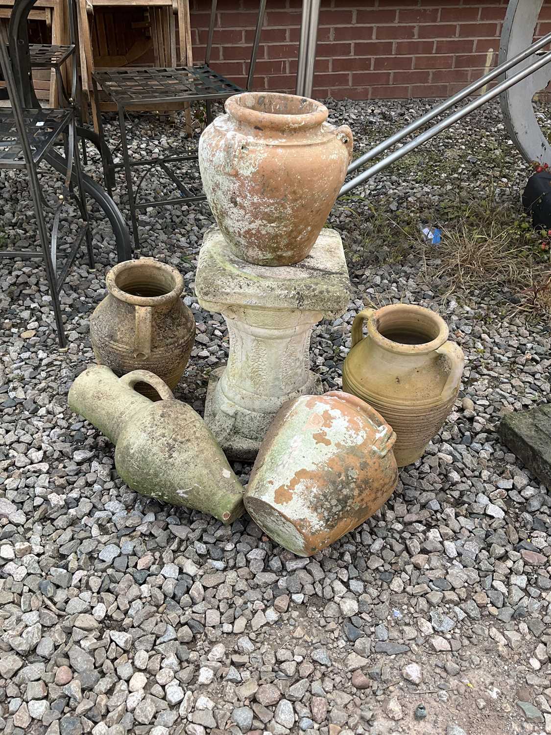 A quantity of terracotta garden pots, urns and a pedestal, tallest 40cm.