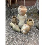 A quantity of terracotta garden pots, urns and a pedestal, tallest 40cm.