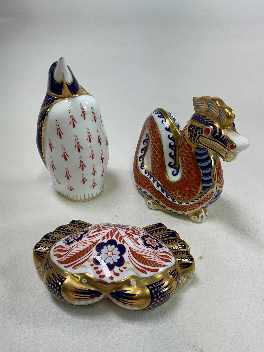ROYAL CROWN DERBY; three paperweights to include a 'Dragon', a 'Galapagos Penguin', and a 'Crab',