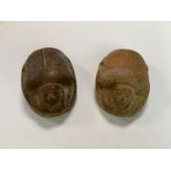 Two large carved stone scarabs with hieroglyphs to their bases, length 9cm.