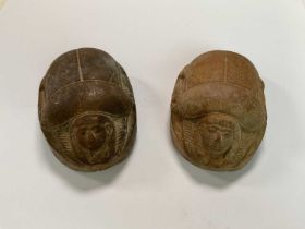 Two large carved stone scarabs with hieroglyphs to their bases, length 9cm.