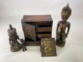 A Japanese table top cabinet and three wooden tribal fertility figures, (all in af condition),