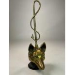 A brass and iron early 20th century doorstop on weighted base modelled as a fox head and whip with