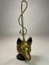 A brass and iron early 20th century doorstop on weighted base modelled as a fox head and whip with