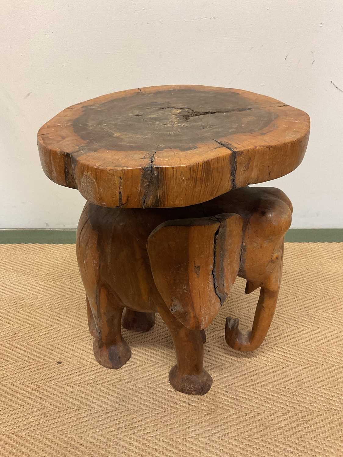 A carved wooden elephant stand, height 39cm, diameter 30cm.