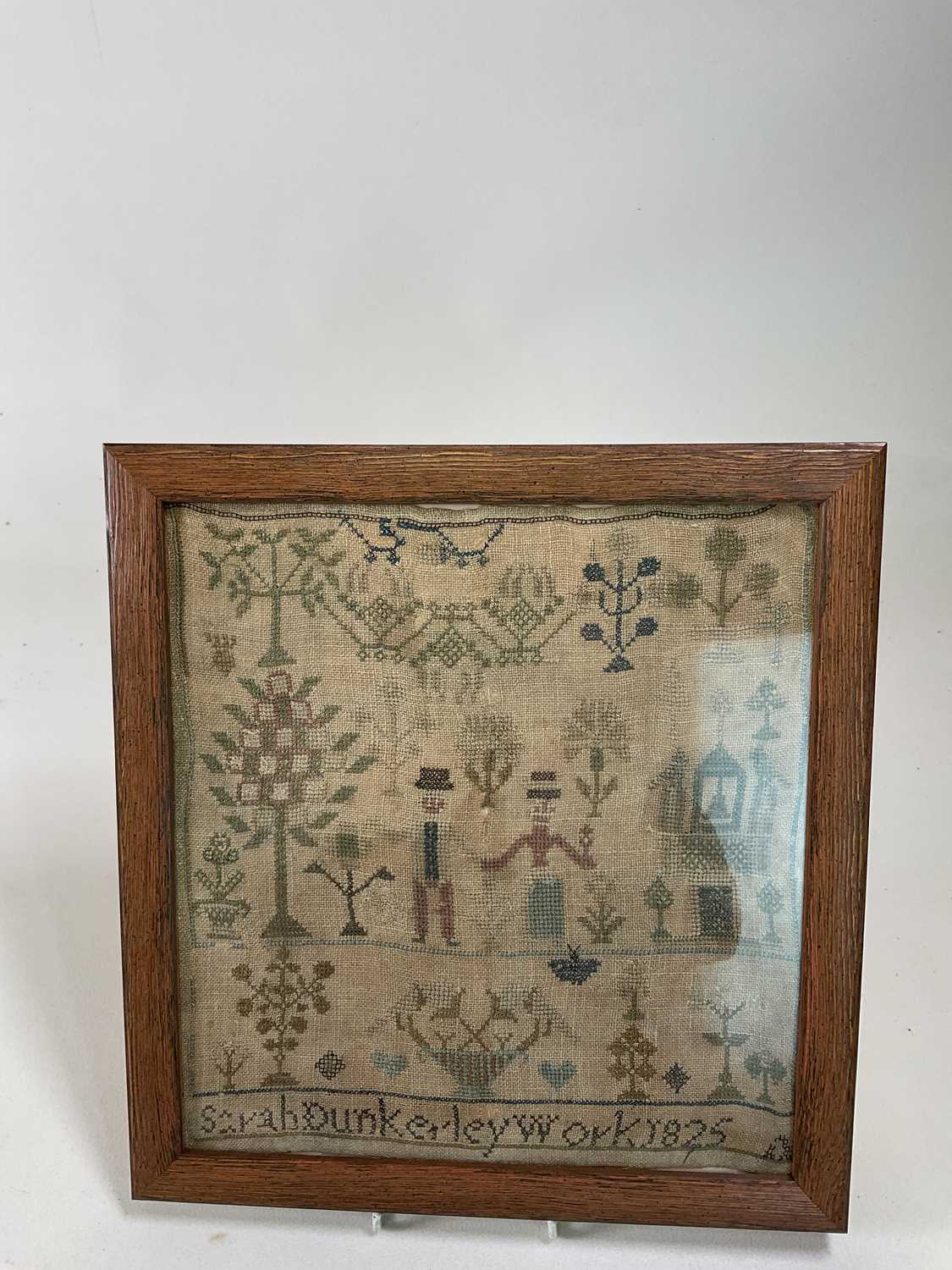 An early 19th century sampler inscribed 'Sarah Dunkerley Work 1825', 30 x 28cm, framed and glazed.