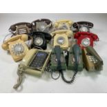 A quantity of vintage dial telephones and trim phones.