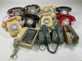 A quantity of vintage dial telephones and trim phones.