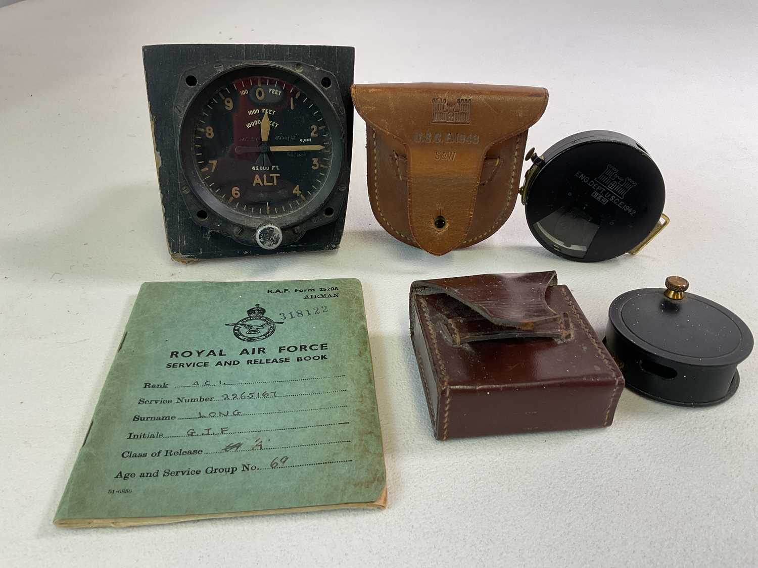 An Aircraft Altimeter and engineers' items, including an RAF service book, a United States Corps