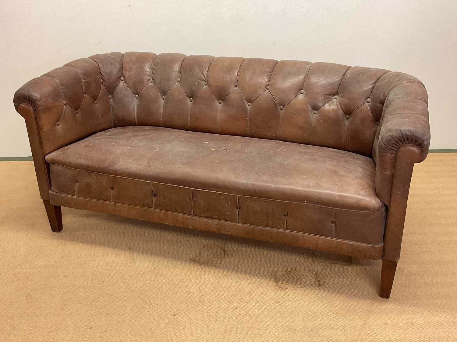 A 1930s Swedish buttonback leather sofa, height 74cm, width 165cm, depth 75cm.