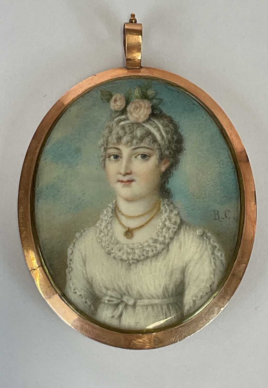 X IN THE MANNER OF RICHARD CROSSE; oval portrait miniature of a young woman with roses in her