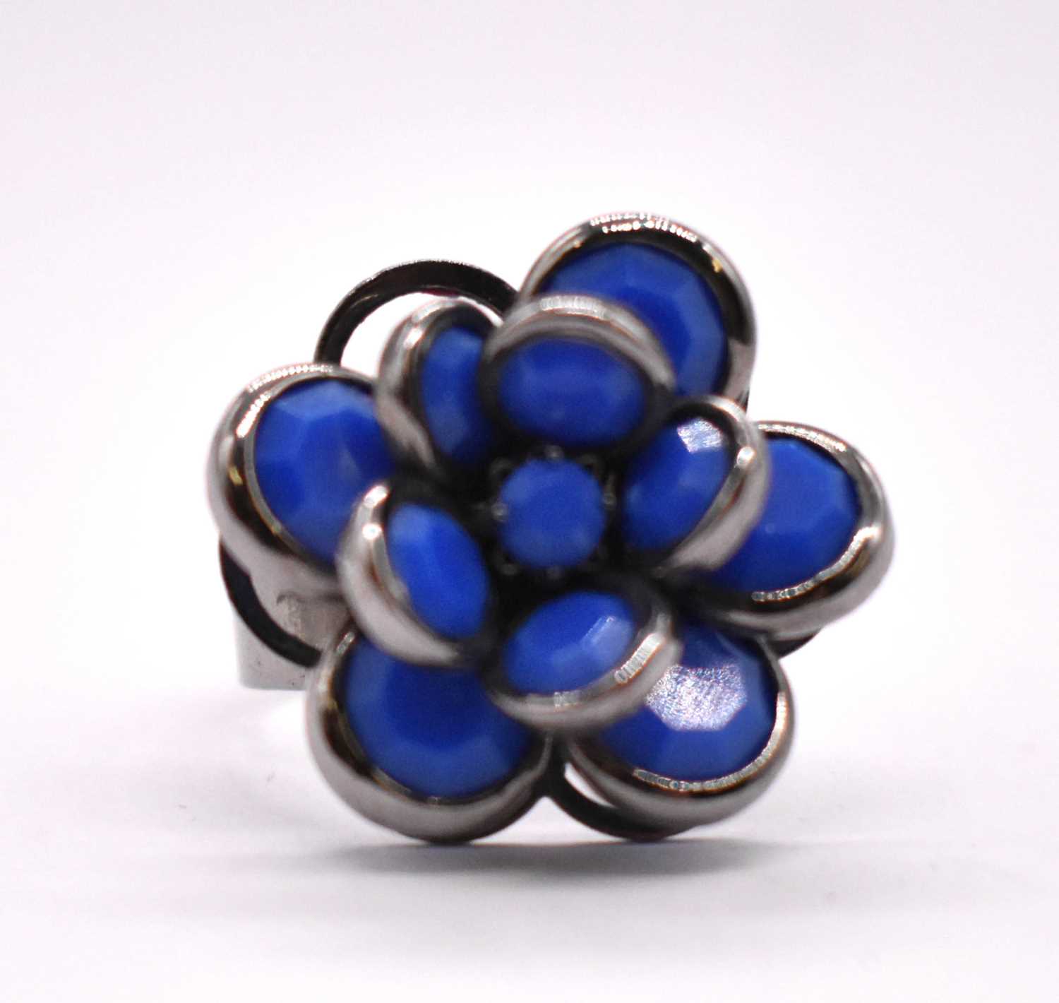 An unusual white metal floral ring, the box inscribed for a Sri Lankan jeweller in Colombo, size