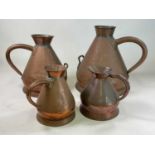 A set of three graduated copper harvest jugs comprising five gallon, three gallon and a one