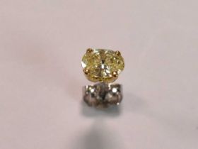 An 18ct white and yellow gold single diamond stud, the oval cut stone weighing approx 0.75ct, four