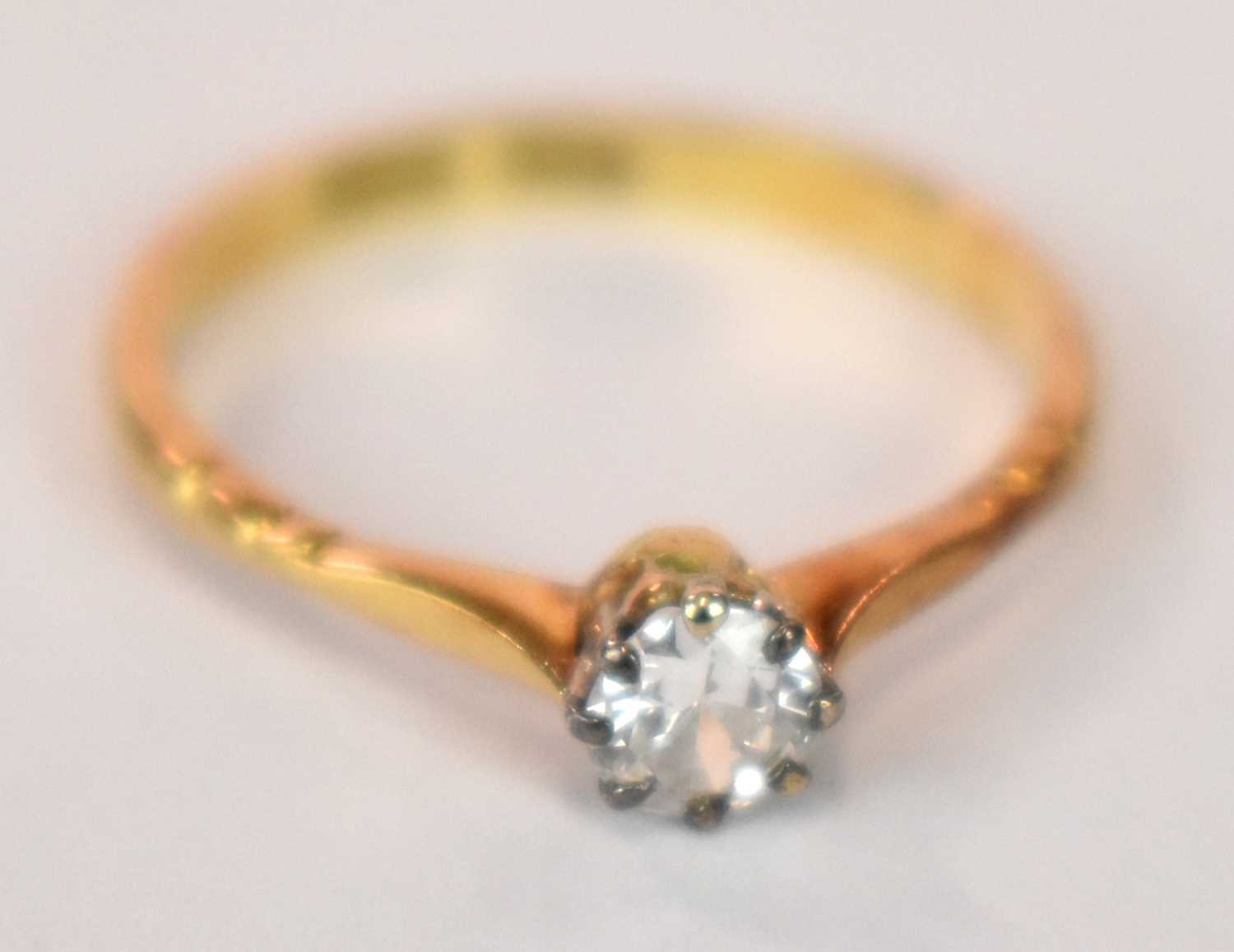 An 18ct yellow gold platinum tipped diamond solitaire ring, the round brilliant cut eight claw set