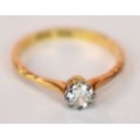 An 18ct yellow gold platinum tipped diamond solitaire ring, the round brilliant cut eight claw set