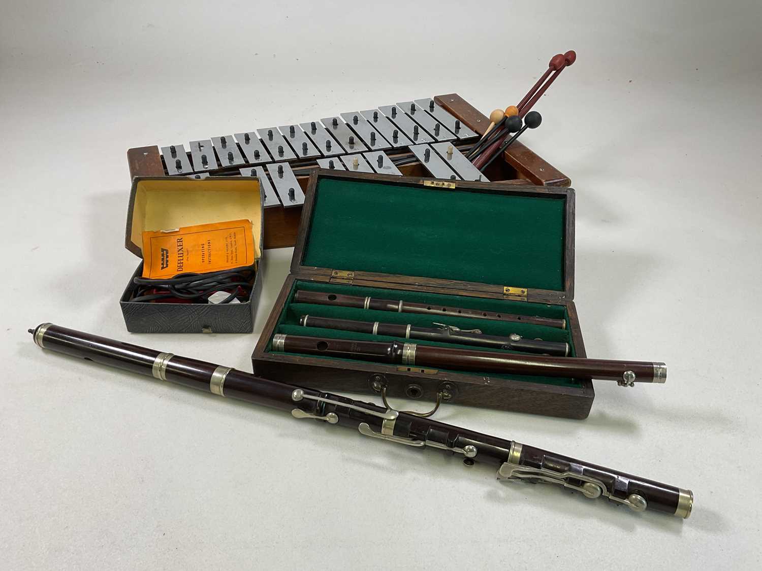 A flute by Rushworth and Dreaper, three piccolos (in box), and a xylophone.