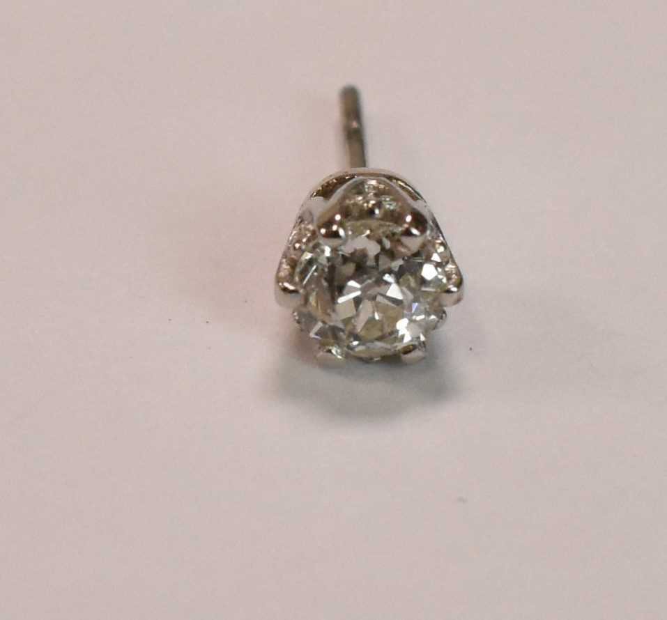 A yellow metal single diamond ear stud, the old round cut stone weighing approx 0.50ct, in six