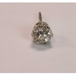 A yellow metal single diamond ear stud, the old round cut stone weighing approx 0.50ct, in six