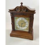 A large oak cased mantel clock, height 38cm.