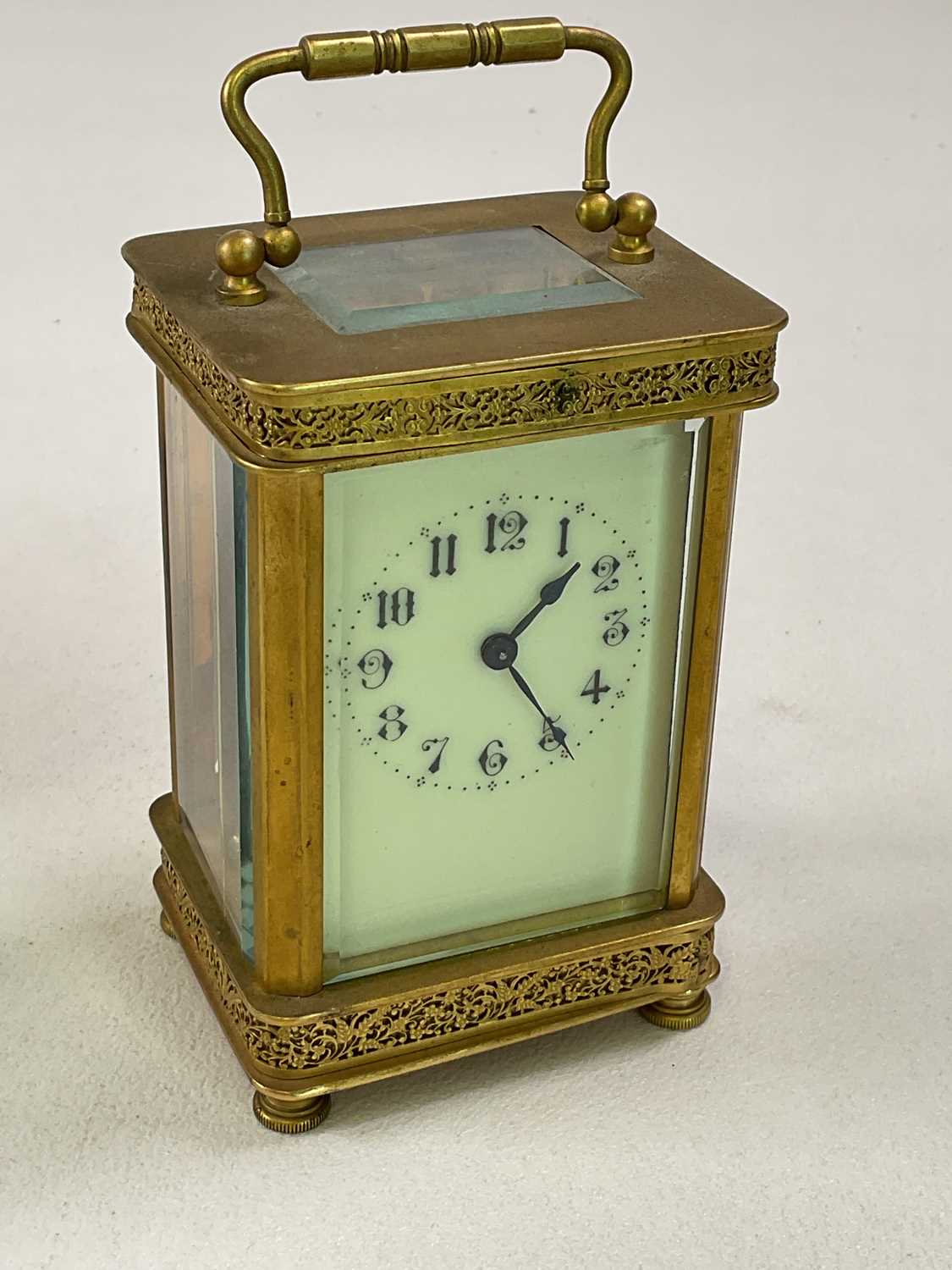 A brass carriage clock with pierced decoration to the case, the enamelled dial set with Arabic - Image 2 of 6