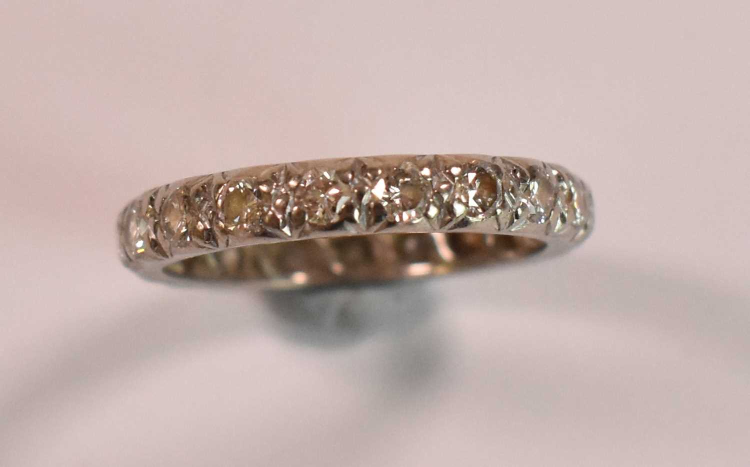 A white metal and diamond set full eternity ring, each round brilliant cut stone weighing approx 0. - Image 2 of 3