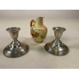 A pair of silver candlesticks, weighted, marked W M Rogers Sterling to base and a Royal Worcester