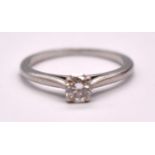 CARTIER; a platinum and diamond solitaire ring, the four claw set round brilliant cut stone weighing