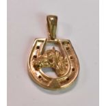 A 9ct yellow gold pendant in the form of a horse's head within a horseshoe, approx 11.2g.