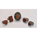 A very large white metal ring centred with a carnelian set with Arabic script within a border of