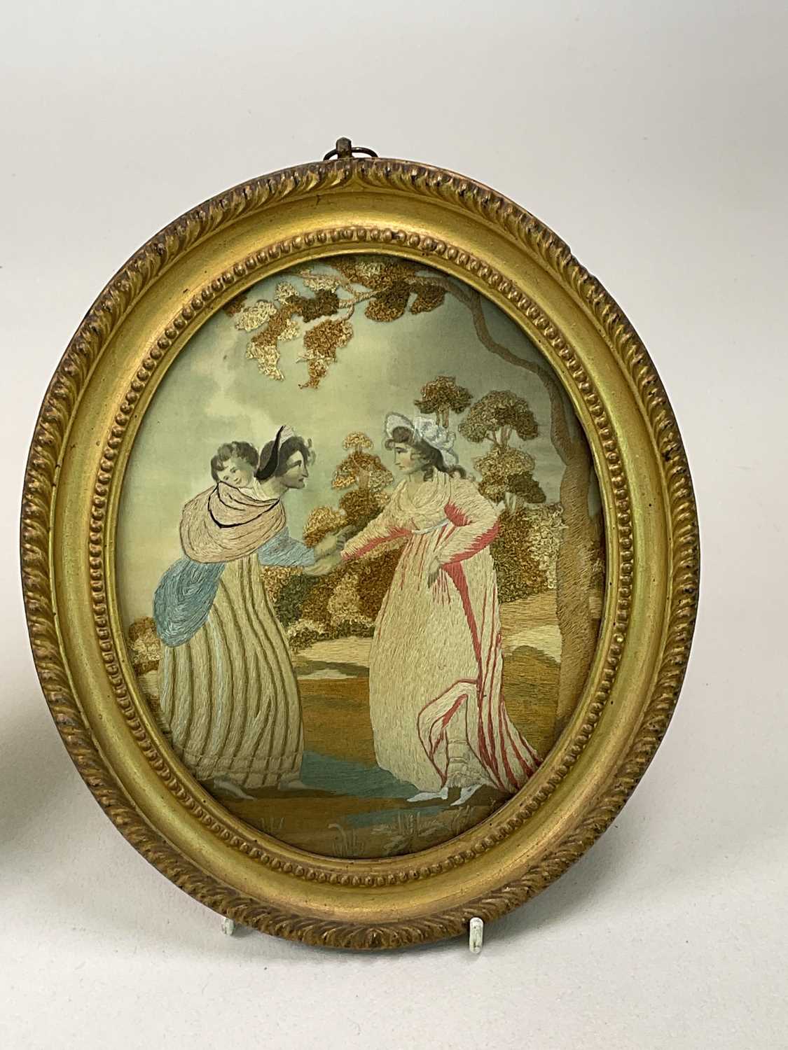 A pair of Georgian oval silk work embroideries in gilt frames, with two miniatures, a - Image 3 of 7