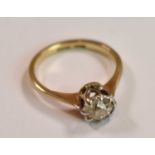 An 18ct yellow gold platinum tipped diamond solitaire ring, the old cushion cut stone weighing